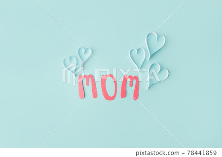 Mothers day message on paper cut hearts over blue background, simple diy creative idea, banner, greeting card for mom Mothers day message on paper cut hearts over blue background, simple diy creative idea, banner, greeting card for mom 78441859