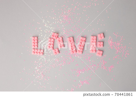 Word Love made of pink kids construction on grayk background. Valentine's Day concept. Flat lay, top view. Naiv art, preschool children hobby, mom day creative idea Word Love made of pink kids construction on grayk background. Valentine's Day concept. Flat lay, top view. Naiv art, preschool children hobby, mom day creative idea 78441861