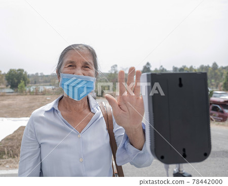 The Asian elderly tourist woman has checked body temperature with a thermal Temperature scanner detector travel safety The Asian elderly tourist woman has checked body temperature with a thermal Temperature scanner detector travel safety 78442000