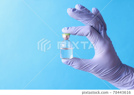 Doctor in medical rubber gloves holding jar of medicine closeup 78443616