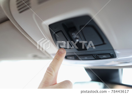 Man with his finger pressing emergency button in car closeup 78443617