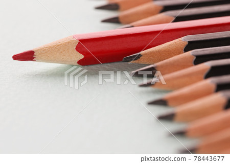 Red sharp wooden pencil lying beyond black closeup background 78443677