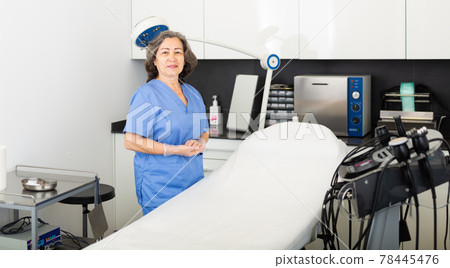Confident professional elderly woman cosmetologist standing in office Confident professional elderly woman cosmetologist standing in office 78445476