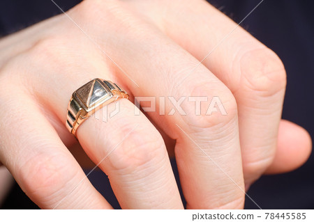 Golden ring on a man finger. Golden ring on a man finger. 78445585