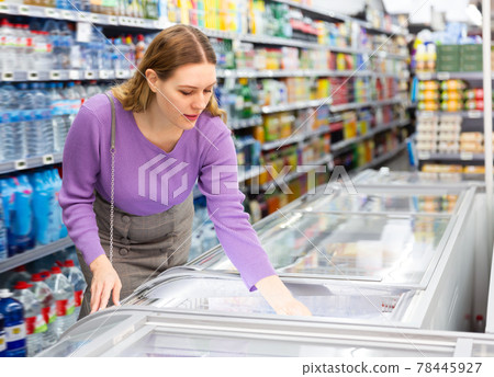 Portrait of nice woman choosing frozen food Portrait of nice woman choosing frozen food 78445927