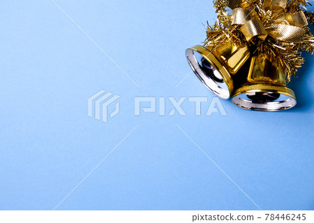Christmas bells with tinsel on blue background with copy space. Christmas bells with tinsel on blue background with copy space. 78446245