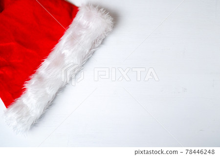 Santa Claus red hat on white wooden background with copy space. Santa Claus red hat on white wooden background with copy space. 78446248
