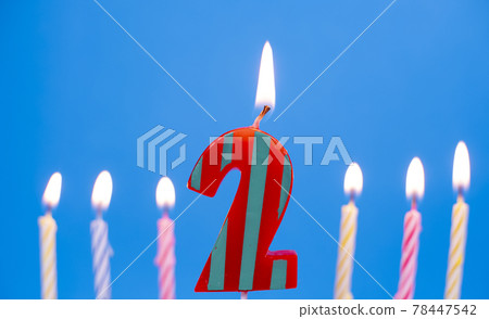 Burning birthday cake candle number 2. Happy Birthday background anniversary celebration concept Burning birthday cake candle number 2. Happy Birthday background anniversary celebration concept 78447542