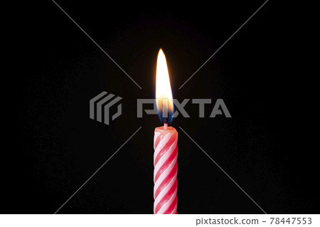 Candle fire at celebration birthday cake blowing at black background isolated. Pink candle Candle fire at celebration birthday cake blowing at black background isolated. Pink candle 78447553