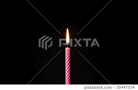 Candle fire at celebration birthday cake blowing at black background isolated Candle fire at celebration birthday cake blowing at black background isolated 78447554