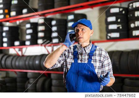 Car mechanic calls on smartphone to client 78447602