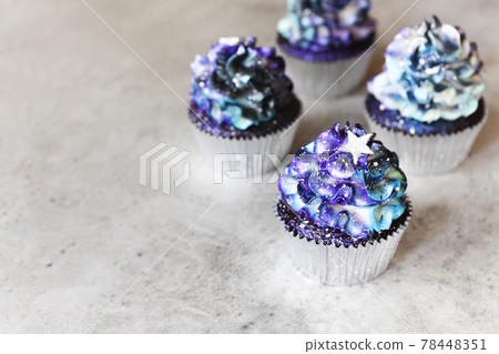 Galaxy colored cupcakes on table 78448351