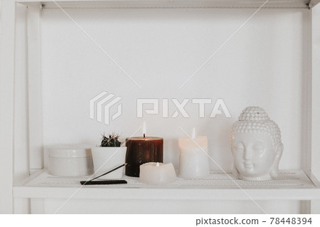 Candles and incense near Buddha head and cactus Candles and incense near Buddha head and cactus 78448394