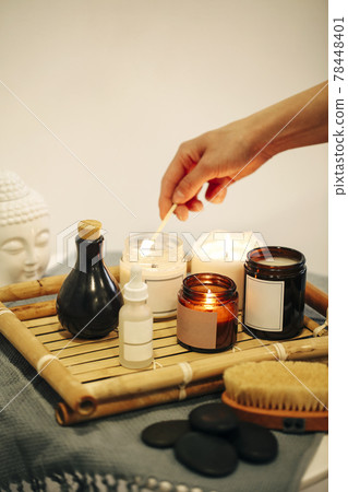 Crop person lighting aromatic candle Crop person lighting aromatic candle 78448401