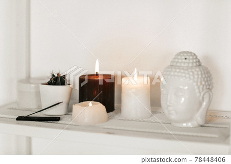 Candles and incense near Buddha head and cactus Candles and incense near Buddha head and cactus 78448406