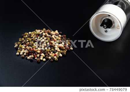 electric pepper shaker and peas on a black background. 78449079