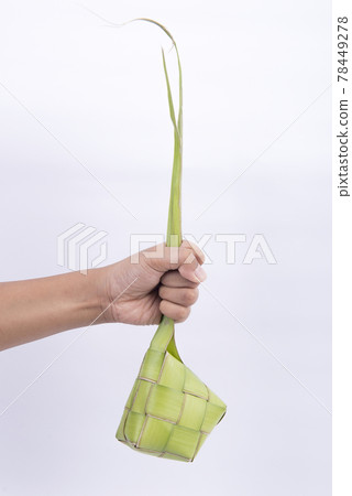 Hand holding ketupat (Rice Dumpling) is a traditional food of Indonesia during Eid Mubarak Hand holding ketupat (Rice Dumpling) is a traditional food of Indonesia during Eid Mubarak 78449278