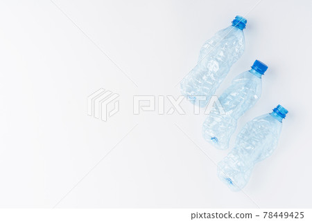 Empty and crushed bottles of water isolated on white background with copyspace. Plastic recycling concept 78449425