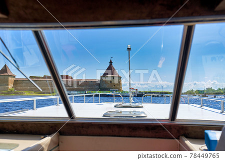 View from the cabin of a tourist boat to the old fortress View from the cabin of a tourist boat to the old fortress 78449765