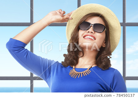 Asian woman standing with hat and sunglasses on the resort Asian woman standing with hat and sunglasses on the resort 78450137
