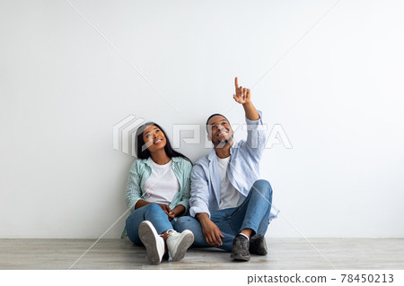 Dreaming african american couple planning interior, decorations and furniture in their own house, empty space 78450213
