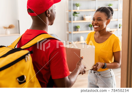 Black Male Courier Giving Box To Female Customer At Home 78450234