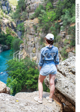 landscape in Manavgat Turkey. happy girl on the steep slope. valley and cliff. Koprulu national Park 78450504