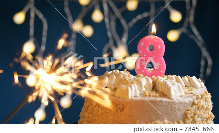 Birthday cake with 8 number pink candles and burning sparkler on blue backgraund. Close-up Birthday cake with 8 number pink candles and burning sparkler on blue backgraund. Close-up 78451666