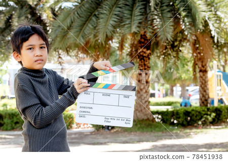 Asian boy holding film slate colors board for movie cinema and television industry 78451938