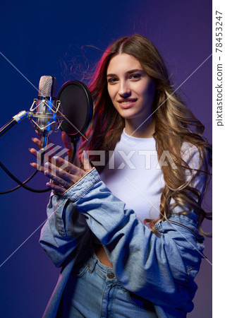 Girl blogger recording audio podcast or singer Girl blogger recording audio podcast or singer 78453247