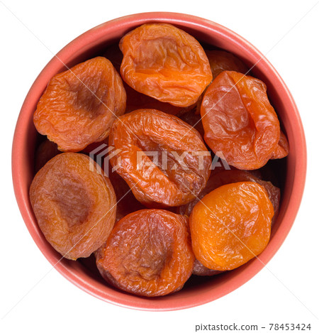 Dried apricots in brown cup isolated on white 78453424