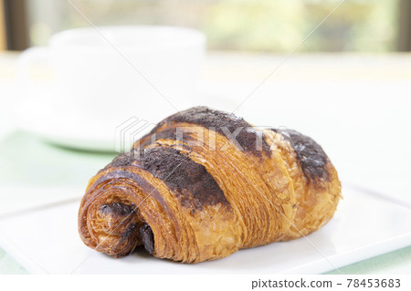 Delicious chocolate croissants and hot coffee Delicious chocolate croissants and hot coffee 78453683