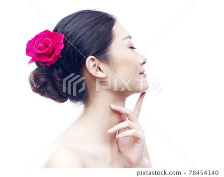 studio portrait of a young asian woman, eyes closed, side view, isolated on white. 78454140