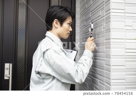 Salesman examining the outer wall with a loupe Salesman examining the outer wall with a loupe 78454158
