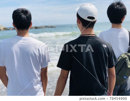 Three men looking at the sea Three men looking at the sea 78454998