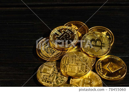 Closeup golden coin with bitcoin logo. Leader in cryptocurrency Bitcoin BTC on a top of coins against black wooden surface. Pile of decentralized digital currency. Crypto payment. Electronic money. Closeup golden coin with bitcoin logo. Leader in cryptocurrency Bitcoin BTC on a top of coins against black wooden surface. Pile of decentralized digital currency. Crypto payment. Electronic money. 78455060