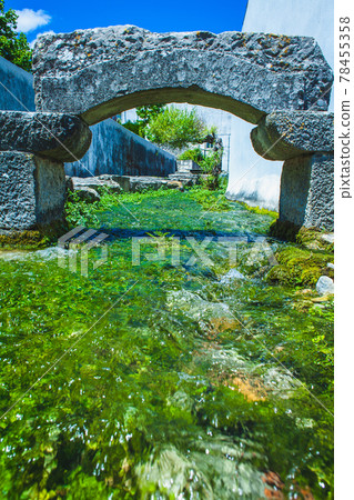 a creek with an stone arch a creek with an stone arch 78455358