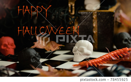 Halloween sculls on chess board and in chest. Spooky Halloween sculls on chess board and in chest. Spooky 78455925