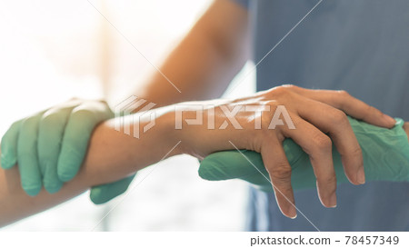 Surgeon, surgical doctor holding patient hand in professional ER emergency operation room for health care trust, medical anesthetic safety by anesthetist or anesthesiologist healthcare support concept 78457349