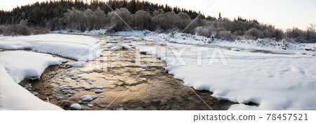 Water flowing between ice and snow in a river in winter Water flowing between ice and snow in a river in winter 78457521