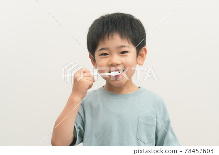 Boy brushing his teeth with a toothbrush 78457603