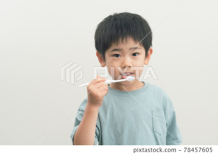 Boy brushing his teeth with a toothbrush Boy brushing his teeth with a toothbrush 78457605