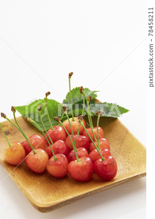 Early summer fruit cherries with leaves on a white background Early summer fruit cherries with leaves on a white background 78458211
