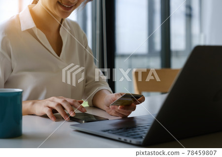 Enjoy wonan's hands typing mobile keyboard and holding credit card online shopping Enjoy wonan's hands typing mobile keyboard and holding credit card online shopping 78459807