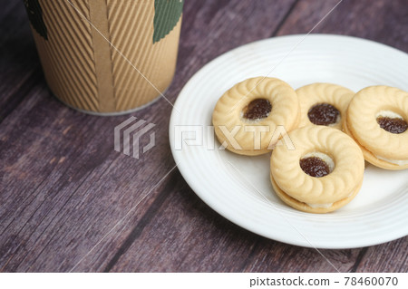 Close up of cherry cookies and coffee on table  78460070