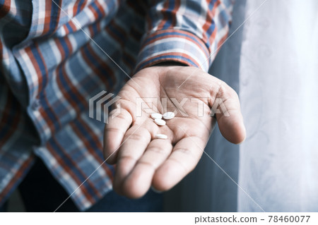 close up of white color medical pill on palm of hand  78460077