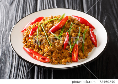 Thai southern traditional style Spicy roasted mince pork with yellow curry paste Khua Kling in Thai close up in the plate. Horizontal Thai southern traditional style Spicy roasted mince pork with yellow curry paste Khua Kling in Thai close up in the plate. Horizontal 78460250