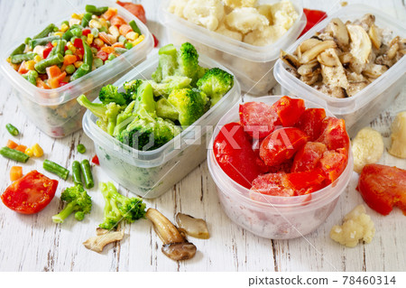 Frozen vegetables. Stocks of food for the winter. Container with frozen vegetables and mushrooms. Frozen vegetables. Stocks of food for the winter. Container with frozen vegetables and mushrooms. 78460314