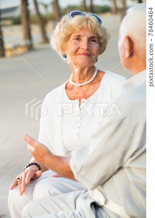 mature female sitting and talking with man 78460464