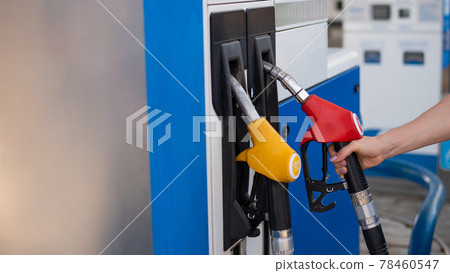 Woman refueling car with gasoline at self-service gas station. Woman refueling car with gasoline at self-service gas station. 78460547